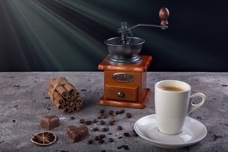 Coffee grinder and a cup of coffeeの写真素材