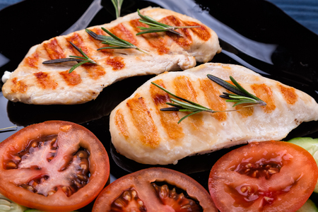 Top view of grilled chicken steaks with vegetablesの写真素材