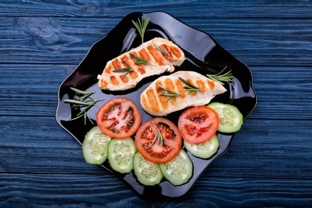 Top view of grilled chicken steaks with vegetablesの写真素材