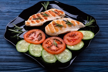 Top view of grilled chicken steaks with vegetablesの写真素材