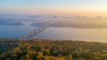 Skyline, Kiev city with beautiful morning sky. Pedestrian bridge. Left bank the Dnieper River.の写真素材