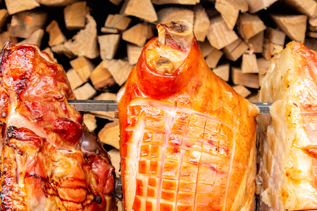 A spit for cooking roast shank in Prague on a Sunny day. A big piece of meat. National cuisine.の写真素材
