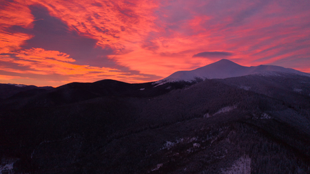 Beautiful winter sunrise in the mountains, shot from the air.の写真素材