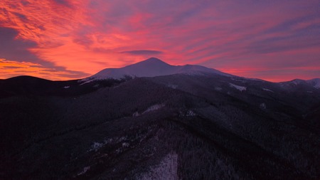 Beautiful winter sunrise in the mountains, shot from the air.の写真素材