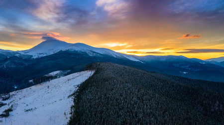 Beautiful winter sunrise in the mountains, shot from the air.の写真素材