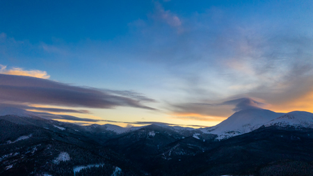 Beautiful winter sunrise in the mountains, shot from the air.の写真素材