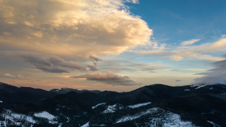 Beautiful winter sunrise in the mountains, shot from the air.の写真素材