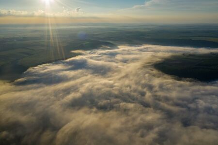 Canyon river in fog shooting from the air