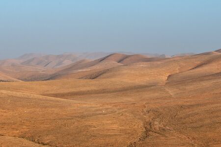 little caravan riding by desert between dune in Moroccoの写真素材