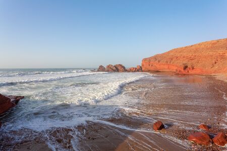 Red archs on atlantic ocean coast. Marocco