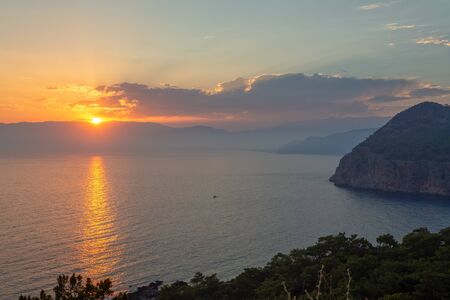 Picturesque Mediterranean seascape in Turkey. Dramatic sunrise in a small bay near the Tekirova village, District of Kemer, Antalya Province.の写真素材