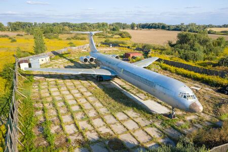 Aerial drone top view photo of abandoned passenger air plane in old airport no longer usedの写真素材