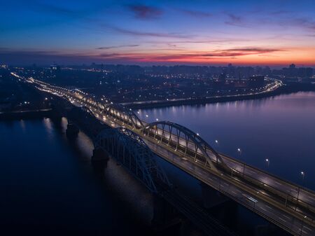 Busy traffic on the lantern-lit bridge of the night city.の写真素材