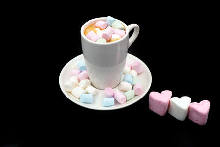 Coffee in white cups and small marshmallows. Turkish coffee, marshmallows on a dark background. Close-up. Two cups of coffee with marshmallows, coffee beansの写真素材