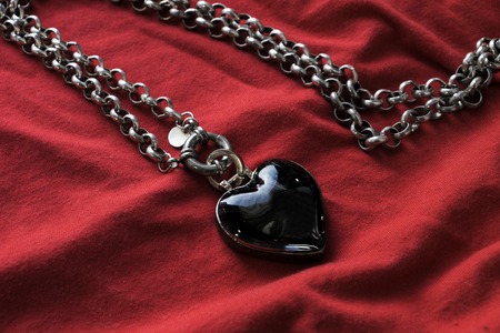 Jewelry in the form of heart on Valentined Day on a red backgroundの写真素材