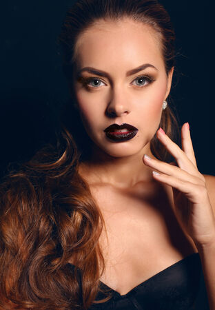 fashion studio photo of beautiful young woman with dark curly hair and evening makeupの写真素材