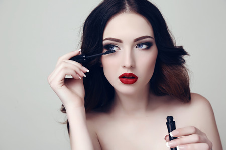 fashion studio portrait of beautiful sexy woman with dark hair and bright makeup with mascaraの写真素材