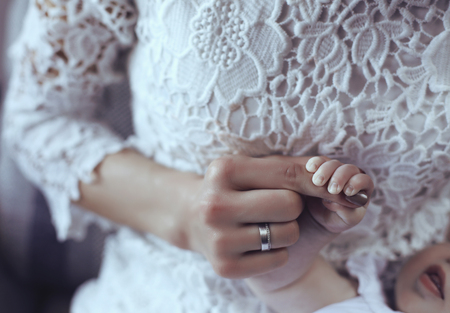 tender interior photo of cute baby hand in mom handsの写真素材