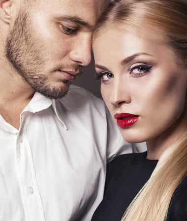 fashion studio photo of impassioned couple. gorgeous woman with blond hair posing with handsome manの写真素材