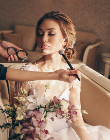 fashion interior photo of beautiful  woman with blond hair in luxurious wedding dress and accessoriesの写真素材