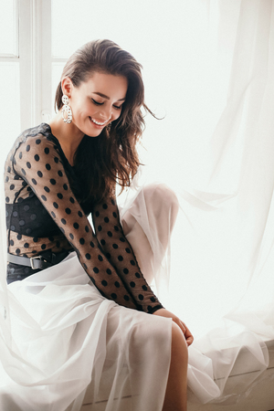 fashion interior photo of beautiful sexy woman with dark hair in elegant chic lace dressの写真素材