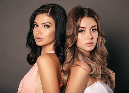 fashion studio photo of beautiful sexy women in elegant dressesの写真素材