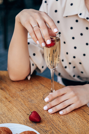 fashion  photo of beautiful sensual woman with dark hair in elegant clothes posing in outdoor cafeの写真素材