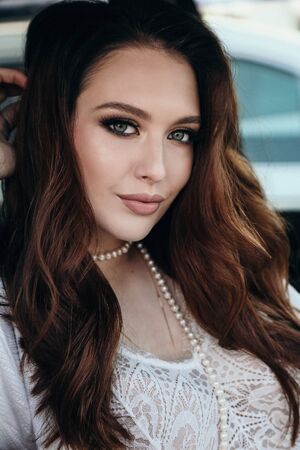fashion outdoor photo of beautiful sensual woman with dark hair in elegant clothes posing in...