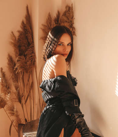 fashion studio photo of beautiful sexy woman with dark short hair in elegant lingerie and leather jacketの写真素材