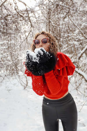 fashion outdoor photo of beautiful woman with dark hair in elegant warm clothes posing in winter...
