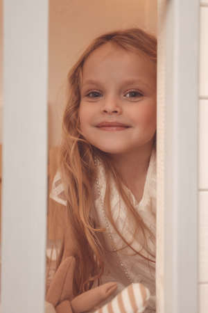 fashion photo of beautiful cute little girl posing in decorated studioの写真素材