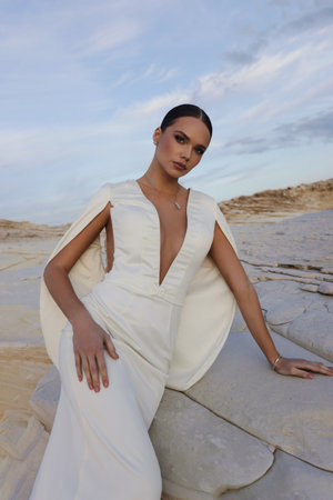 fashion outdoor photo of beautiful bride in luxurious wedding dress posing on the beach in Cyprusの写真素材
