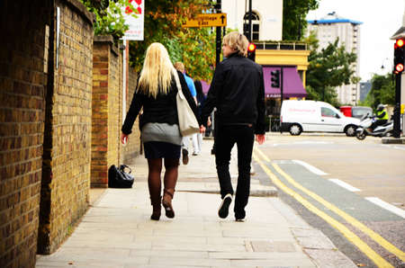 A young couple is walking on the street, holding hands.のeditorial素材