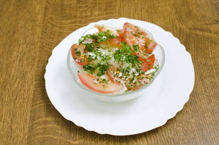 Salad in a transparent cup placed on a plate.の写真素材