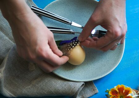 Easter holiday decorating with egg and featherの写真素材