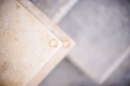 one wedding ring lies on the ledge of the wall and against the background of it lies the second ring in defocusの写真素材