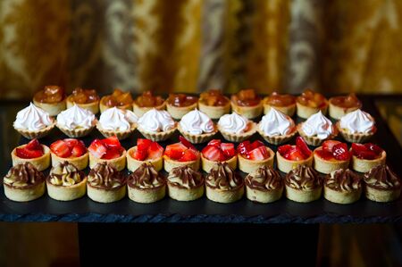 sweet snacks at the buffet table, different canapesの写真素材