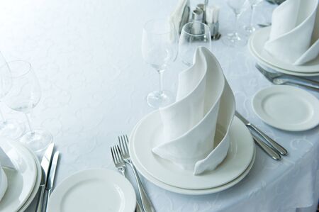Served table seat in bright colors with a beautifully laid out napkinの写真素材