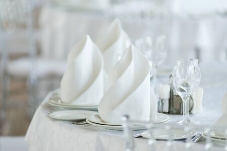 Served table seat in bright colors with a beautifully laid out napkinの写真素材