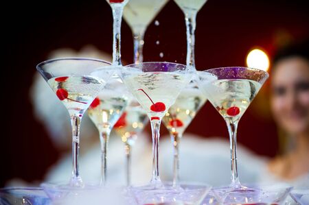 glasses with champagne stand on top of each other. Fragment of a champagne slideの写真素材