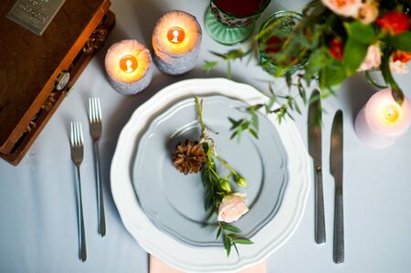turquoise-colored table with gold plates and cutleryの写真素材