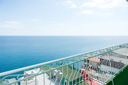 view of the Black Sea and various buildings from the balcony with white railings at an inexpensive resortの写真素材