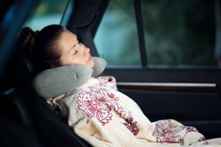young woman sleeping in the backseat of a car. Travel concept