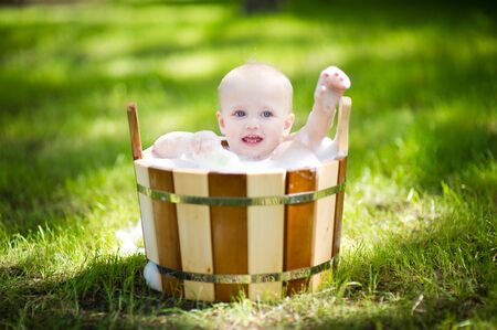 little girl in a tub with foam