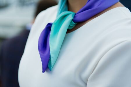 part of a white jacket and a green scarf on a girl, close-up, mock upの写真素材