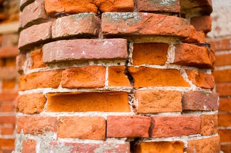 pillar, part of an antique building with a crumbling brick. close up