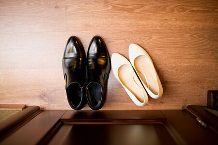 the bride and groom shoes are standing near the door. top viewの写真素材