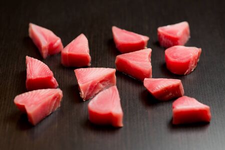 slices of fresh tuna on a black table, selective focusの写真素材
