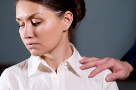 the girl rejects the fact that a man touches her shoulder, turns away from this gestureの写真素材