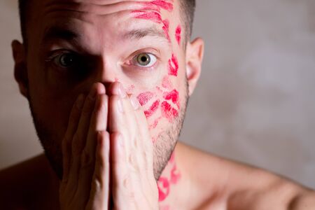 kissed man in a state of passion wide-eyed, close upの写真素材